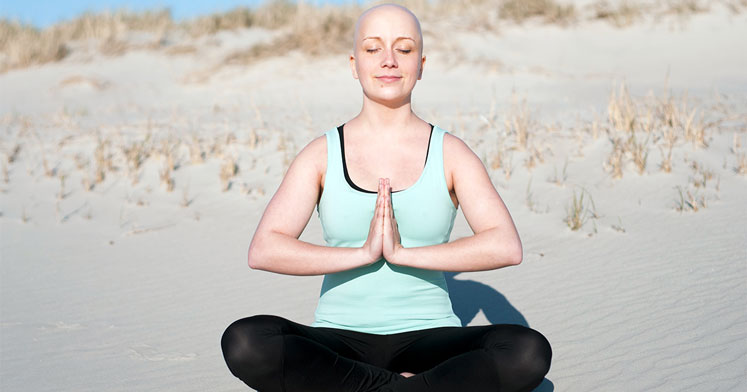 Kumsalda yoga yapan kanser hastası kadın