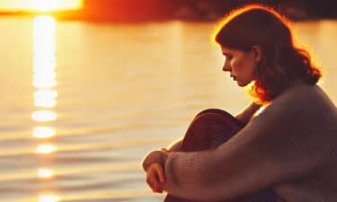 a woman sitting on a dock